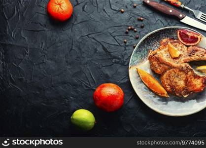 Baked pork with red orange marinade. Space for text. Meat fried in orange sauce,copy space