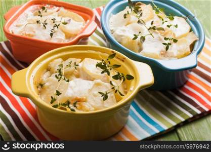 Baked potato casserole with cream sauce with thyme, gratin Dauphinois