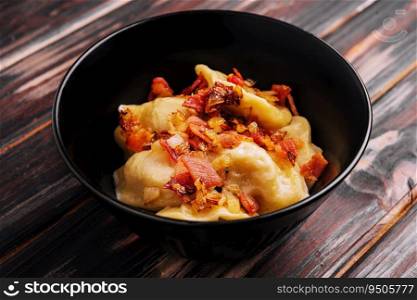 Baked potato dumplings with fried bacon and onions
