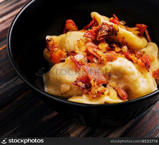 Baked potato dumplings with fried bacon and onions