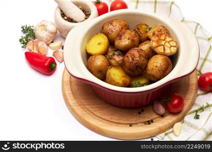 Baked potato in a clay pot isolated on white background. High quality photo. Baked potato in a clay pot isolated on white background