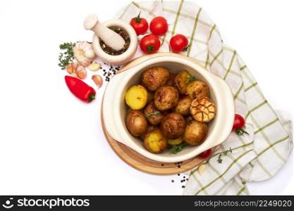 Baked potato in a clay pot isolated on white background. High quality photo. Baked potato in a clay pot isolated on white background