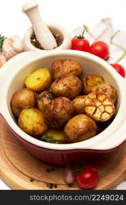 Baked potato in a clay pot isolated on white background. High quality photo. Baked potato in a clay pot isolated on white background