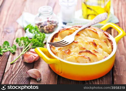 baked potato in bowl and on a table