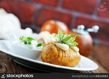 baked potato on plate and on a table