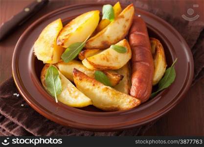 baked potato wedges and sausage in plate over brown rustic table