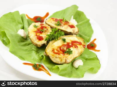 Baked potatoes filled with ham, eggs and cheese, decorated with parsley, ketchup, mayonnaise and lettuce