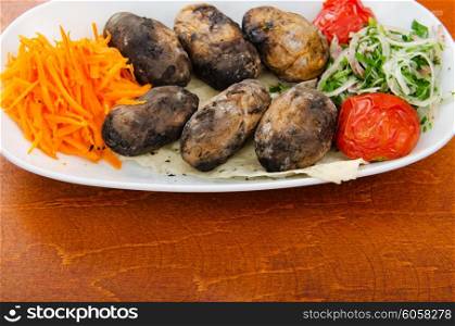 Baked potatoes in the plate