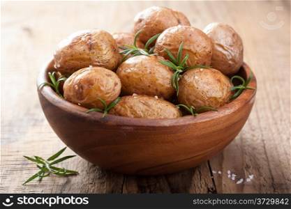 baked potatoes in wooden bowl