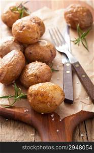 baked potatoes on chopping board