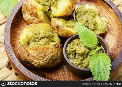 Baked potatoes stuffed with herbs and nettle leaves. Baked unpeeled potatoes