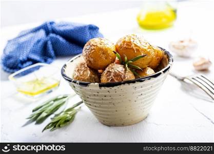 baked potatoes whole in their skins with rosemary and garlic