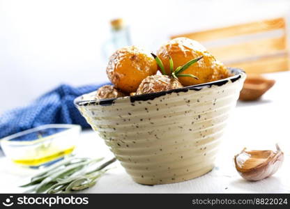 baked potatoes whole in their skins with rosemary and garlic