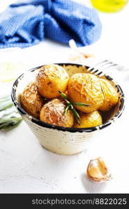 baked potatoes whole in their skins with rosemary and garlic