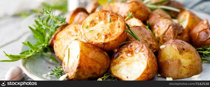 Baked potatoes with rosemary, thyme and garlic. Banner