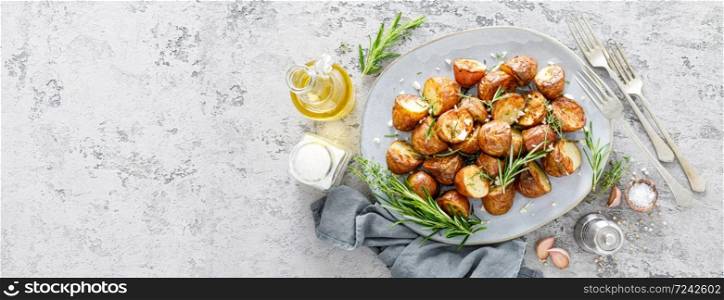 Baked potatoes with rosemary, thyme and garlic. Banner