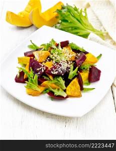 Baked pumpkin, boiled beetroot, arugula salad seasoned with vinegar, spices, orange juice and vegetable oil in a plate, napkin on white wooden board background