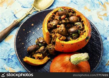 Baked pumpkin stuffed with mushrooms and rice. Traditional autumn food. Pumpkin stuffed with mushrooms