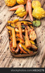 Baked pumpkin with carrots and quince. autumn vegetarian food, baked carrot, pumpkin and quince