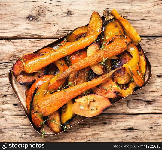 Baked pumpkin with carrots. vegetarian dish with baked carrot, pumpkin and quince