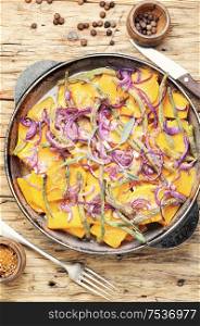 Baked pumpkin with red onion and vigna.Stewed vegetables. Baked pumpkin slices in pan