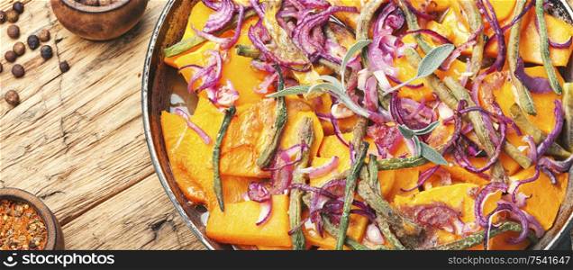 Baked pumpkin with red onion and vigna.Stewed vegetables. Baked pumpkin slices in pan