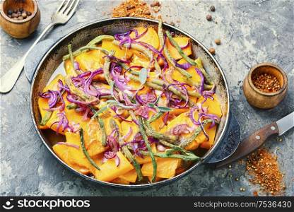 Baked pumpkin with red onion and vigna.Stewed vegetables. Roasted pumpkin with with vegetables