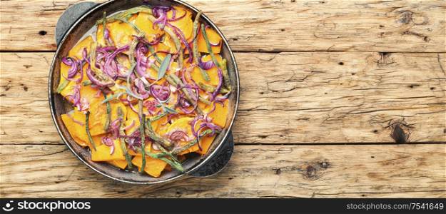 Baked pumpkin with red onion and vigna.Stewed vegetables.Space for text. Baked pumpkin slices in pan