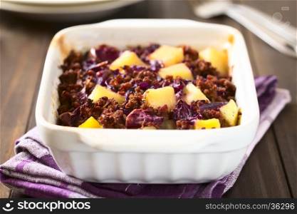 Baked red cabbage, apple, mincemeat and potato casserole in dish, photographed with natural light (Selective Focus, Focus one third into the dish)
