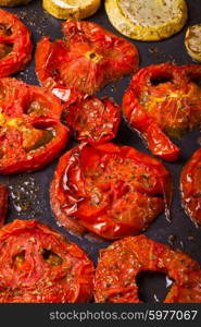 Baked red tomato rings on the frying pan. Baked carrots