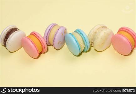 baked round macarons on a beige background, delicious dessert, top view