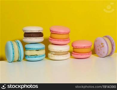 baked round macarons on a yellow background, delicious dessert