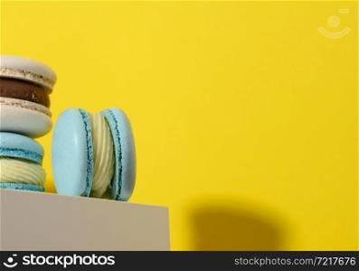 baked round macarons on a yellow background, delicious dessert