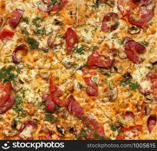 baked round pizza with smoked sausages, mushrooms, tomatoes, cheese and dill, sliced food, full frame, close up