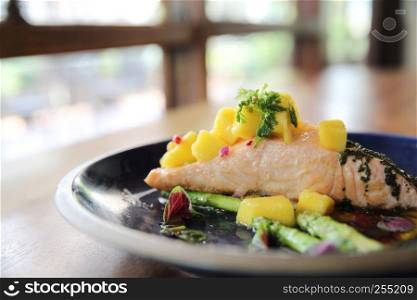 Baked salmon fillet with rosemary, lemon and mango