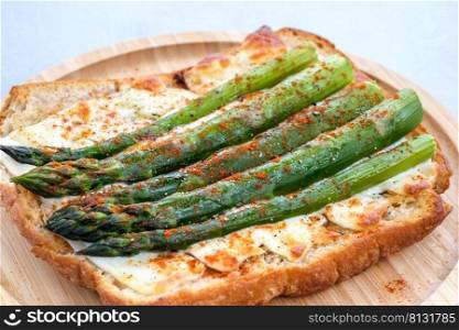 Baked sandwich with asparagus sprouts and mozzarella