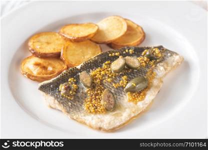 Baked sea bass with capers and fried potatoes