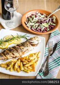 Baked seabass with fried potatoes