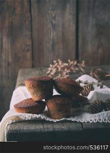 baked small round cupcakes on a white textile napkin, wooden gray background