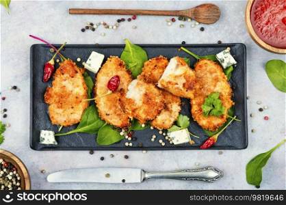Baked spicy juicy chicken breasts in breadcrumbs, chicken meat.. Breaded chicken breast.