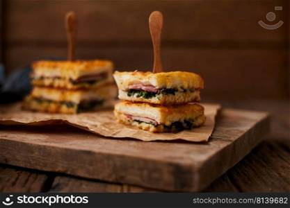 Baked spinach and ham sandwich with sauce.