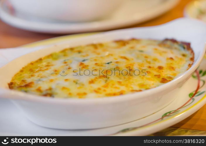 Baked spinach with cheese . close up Baked spinach with cheese in white bowl