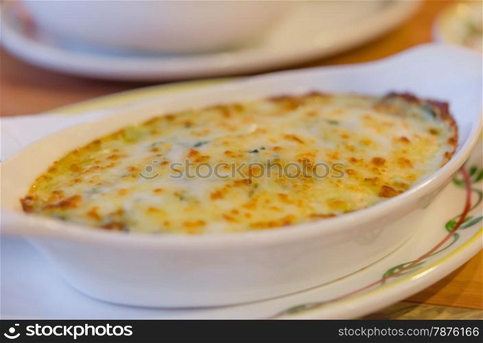 Baked spinach with cheese . close up Baked spinach with cheese in white bowl