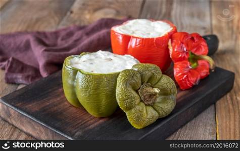 Baked stuffed peppers with ricotta on the wooden board