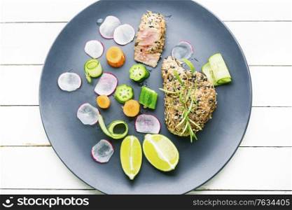 Baked tuna steak with vegetable garnish.Fish cooked with vegetables.. Tuna with vegetables.