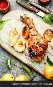 Baked turkey leg with caramelized pear.Appetizing meat dish.. Roasted turkey legs with pear