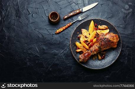 Baked turkey meat in oranges. Roasted turkey leg. Space for text. Baked turkey meat with citrus fruit