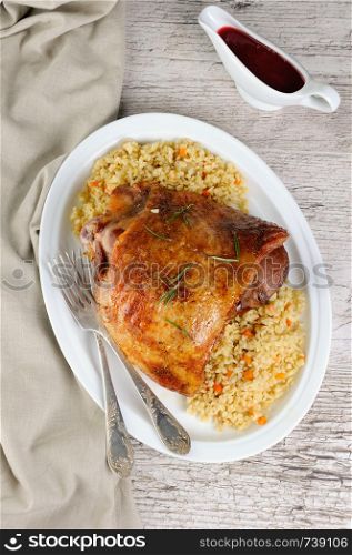 Baked turkey thigh with garnish bulgur and vegetables