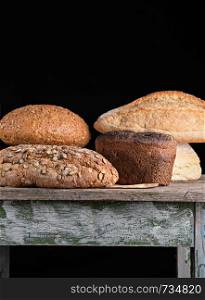 baked various breads , black background, close up