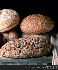 baked various breads , black  background, close up
